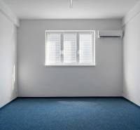 Prenájom klimatizovaná kancelária: 25 m2 a 42 m2 - Trnava Chovateľská - Kancelárie s modrým kobercom, bielymi stenami a klimatizáciou.
