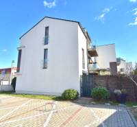 UHLISKÁ, 3-i byt, 80 m2 – zariadená novostavba s parkovaním v cene - Budova so sklenenými balkónmi a parkovací priestor na ulici Uhliská v Bratislave, Vajnory.