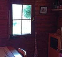 TURANY- krásna chata na pozemku 700m2 - Drevený interiér chaty s oknom a kuchynským kútom, mimo Černíku.