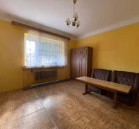 EXKLUZÍVNE - Útulný 3-izbový dom v Čiernom Brode s veľkým pozemkom - Žltá izba v rodinnom dome s dvomi kreslami a stolom, podlaha s dreveným dekorom.
