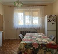 EXKLUZÍVNE - Útulný 3-izbový dom v Čiernom Brode s veľkým pozemkom - Kuchyňa v rodinnom dome s podlahou s dreveným dekorom a kvetinovým obrusom na stole.