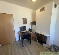 Trojizbový rodinný dom vhodný aj na chalupu v kľudnej časti obce Jatov - Interiér rodinného domu s krbom, pracovným stolom a podlahou s dreveným dekorom.