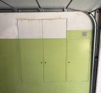 Garáž ul. Eisnerova, Devínska Nová Ves - Garáž v bielej a zelenej farbe má členené úložné skrinky.