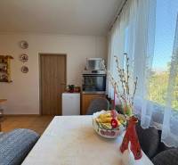 Na predaj: 4 izb.byt + BALKON + ŠATNIK + ŠPAJZA - Jedáleň v 3-izbovom byte so stolom, dekoráciami a výhľadom do zelene.