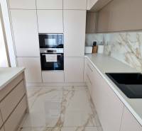PRENÁJOM - 4 izbový rodinný dom, ktorý je súčasťou dvojdomu   - Kuchyňa s bielymi skrinkami, mramorovou podlahou a vstavanými spotrebičmi v rodinnom dome.