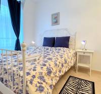 EXKLUZÍVNE, Štýlový 2i byt,, Hviezdoslavovo námestie, Staré.Mesto  - Svetlá spálňa v 2-izbovom byte s bielym nábytkom a modrým závesom.