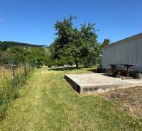 NA PREDAJ krásny pozemok pre váš nový Dom alebo Chalupu - Oplotený pozemok v Nová Baňa s trávou a stromami, ideálny na bývanie.