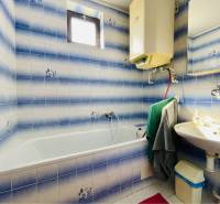 A-W REAL | POSCHODOVÝ DVOJDOM S GARÁŽOU NA PREDAJ V OBCI BÚČ - Kúpeľňa v rodinnom dome s modrobielymi obkladmi, vaňou a umývadlom.