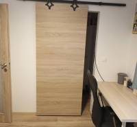 ☎️0904/842-727 Štýlové bývanie - 3izbový byt – Horný Bar - Interiér 3-izbového bytu s posuvnými dverami a podlahou s dreveným dekorom.