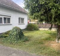 Znížená Cena!Na predaj rodinný dom vo Vrakúni, blízko Dunajskej Stredy - Rodinný dom vo Vrakúni obklopený zeleným trávnikom a stromami, vedľa asfaltového chodníka.