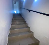 ☎️ 0918197701-Na prenájom menší priestor v suteréne  v srdci  mesta Du - Schodisko s osvetlením vedúce do kancelárií s hladkými bielymi stenami.