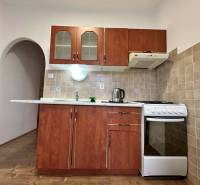 ☎️  0918/197 701  Na prenájom 1 izbový byt s balkónom a pivnicou v mes - Kuchyňa v 1-izbovom byte s kuchynskou linkou a podlahou s dreveným dekorom.