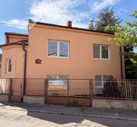 Predaj rodinného domu Piešťany - Rodinný dom na Mlynskej ulici v Piešťanoch s bielymi oknami, oranžovou fasádou a plotom.