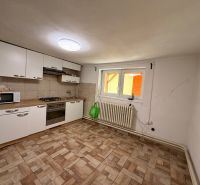 Predaj rodinného domu Piešťany - Kuchyňa v rodinnom dome s dlažbou a bielymi skrinkami.