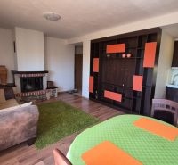 Investičný apartmán Vysoké Tatry - Stará Lesná s balkónom a park.miest - Rekreačný apartmán s podlahou s dreveným dekorom, krbom a kuchynkou, útulný interiér.