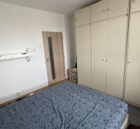 Prenájom 2i-byt s lodžiou s krásnym výhľadom na Račianskej ulici - Spálňa s veľkou šatníkovou skriňou a podlahou s dreveným dekorom v 2-izbovom byte.
