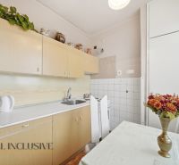 Na predaj 2-izb. byt s pivnicou, Kolárovo - Kuchyňa v 2-izbovom byte s jednoduchou linkou, stolom a dekoratívnymi kvetmi.
