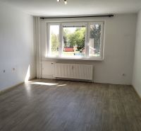 3-izbový byt s možnosťou zmeny na 4-izbový, Martin - Záturčie - Prázdny svetlý interiér s veľkým oknom a podlahou s dreveným dekorom v 3-izbovom byte.