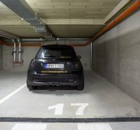 NA PRENÁJOM  2 izbový byt s GARÁŽOU Nitra - Parkovacie miesto v garáži s nápisom na aute, číslom 17 a potrubím na strope.