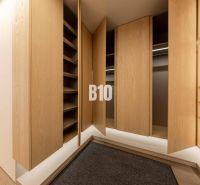 POD VINICAMI - 3IZBOVÉ BYTY V NADŠTANDARDNEJ BOUTIQUE REZIDENCII - Šatník s drevenými dverami a podlahou s dreveným dekorom v 3-izbovom byte.