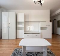 ZNÍŽENÁ CENA 3 izbový MEZONET v obľúbenej lokalite sídliska Juh | Tren - Interiér Rekreačného apartmánu s bielym nábytkom a podlahou s dreveným dekorom.