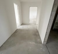 Na predaj 3 izb. byt s balkónom blízko centra - Prázdna miestnosť s bielymi stenami v 3-izbovom byte, dvere vedú do ďalších izieb.