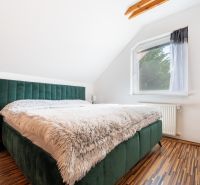 ZNÍŽENÁ CENA -SLNEČNÝ RODINNÝ DOM NA ČIERNEJ VODE - Spálňa v rodinnom dome s posteľou a podlahou s dreveným dekorom.