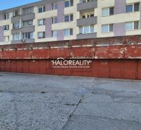 Predaj, garáž Bratislava Vrakuňa, Toryská - EXKLUZÍV... - Garáže v BA - Vrakuni pred obytnými budovami s vyblednutými červenými bránami.