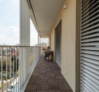 Bývanie ako z katalógu – Dizajnový 3-izbový byt s terasou a parkovaním - Balkón s podlahou s dreveným dekorom v 3-izbovom byte, výhľad na Bratislava - Ružinov.