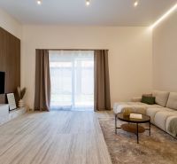 MODERNÝ 4-IZBOVÝ BUNGALOV | ZEMPLÍNSKA ŠIROKÁ - Obývačka rodinného domu so sedačkou, podlahou s dreveným dekorom a televízorom na stene.