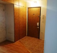 3 izbový byt na sidlisku Stráňany - Vstupná chodba s podlahou s dreveným dekorom v 3-izbovom byte so šatníkovými skriňami.
