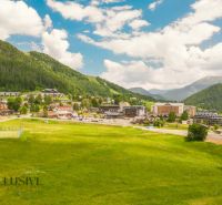 PRIESTRANNÝ 3 IZBOVÝ BYT S TERASOU | DONOVALY  - Panorama Donovaly, obklopená lúkami a horami, z výšky zobrazuje 3-izbové byty.