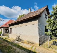 Na predaj 6-izbový rodinný dom (dvojdom) v Pažiti, pozemok 1445 m² - Rodinný dom v Pažiťi obklopený zeleňou, s červenou strechou a drevenými oknami.