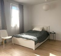 Prenájom 1 izb. byt, NOVOSTAVBA Ivanská cesta, Bratislava II, Trnávka  - Svetlá izba v 1-izbovom byte s posteľou a podlahou s dreveným dekorom.