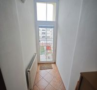 Predaj: Priestranný 2 izb byt 86m2 centrum, ul.ČSA s balkónom  - Úzka chodba s oknom a radiátorom v 2-izbovom byte, dlažba na podlahe.