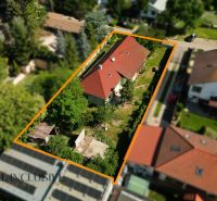 Na predaj 3-izb. rd s veľkým pozemkom, Hviezdoslavov - Rodinný dom v Hviezdoslavove s červenou strechou, obklopený zeleňou a ďalšími stavbami.