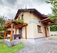 NA PREDAJ KRÁSNA CHATA PRI DUNAJI, MOČA, OKRES KOMÁRNO - Chata v Moči má terasu s drevenou pergolou a zeleňou na ulici Moča.