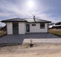 Novostavba v blízkosti  Liptovskej Mary – bungalov - Rodinný dom v Ižipovciach s parkovacími miestami a kachľovou strechou pod slnečnou oblohou.
