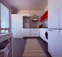 Na predaj: 4 izb.byt + BALKON + PIVNICA - Kuchyňa 4-izbového bytu s bielymi skrinkami a tmavou podlahou s dreveným dekorom.