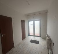 PREDAJ - Rodinný dom s investičným potenciálom - Nové Zámky - Interiér rodinného domu s bielymi stenami, keramickou podlahou a drevenými dverami.