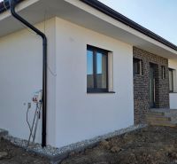 Bungalov v centre obce Cabaj v štandarde, Wágnerova ulica, Dom č.2 - Rodinný dom v Cabaj-Čápore s kombináciou bielej fasády a tehlového dekoru.