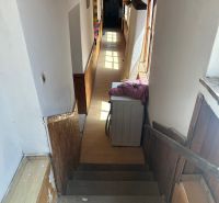 Na predaj starší rodinný dom v obci Budmerice 541m2 - Interiér rodinného domu s úzkou chodbou, schodiskom a práčkou.