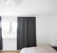 Na Prenájom krásny klimatizovaný mezonet v Pezinku 1.100,- Eur - Na obrázku je svetlá izba s posteľou a závesmi na ulici Trnavská.