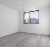 Na predaj nový moderný 4-izbový rodinný dom s terasou a záhradou - Prázdna izba v rodinnom dome s oknom a podlahou s dreveným dekorom.