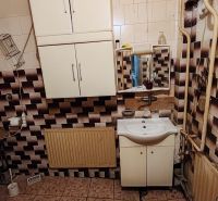 Rodinný dom na predaj Komárno - Kúpeľňa v rodinnom dome s kachličkami a umývadlovou skrinkou.