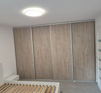 Na prenájom kompletne prerob. NOVÝ 2 izbový byt čiast.zar. Nové Zámky - Spálňa s vstavanou skriňou, posteľou a bielymi stenami v 2-izbovom byte.