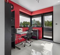 ARCHITEKTÚRA TICHA A MODERNÝCH TECHNOLÓGIÍ - SMART VILLA V OBJATÍ LESA - Domáca pracovňa v rodinnom dome s červenými stenami, čiernym nábytkom a vstupom na terasu.