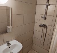 Na prenájom 1 izbový byt v Komárne - Kúpeľňa v 1-izbovom byte so sprchou a umývadlom, dlažba s neutrálnym vzorom.