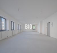 ADMINISTRATÍVNY PRIESTOR (127,87 m²) V NOVOSTAVBE REZIDENCIA KUBÍN V C - Priestranné kancelárie s viacerými oknami a závesnými svietidlami, biela podlaha.
