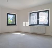 ADMINISTRATÍVNY PRIESTOR (127,87 m²) V NOVOSTAVBE REZIDENCIA KUBÍN V C - Interiér kancelárie s bielymi stenami, sivou podlahou a dvoma oknami.